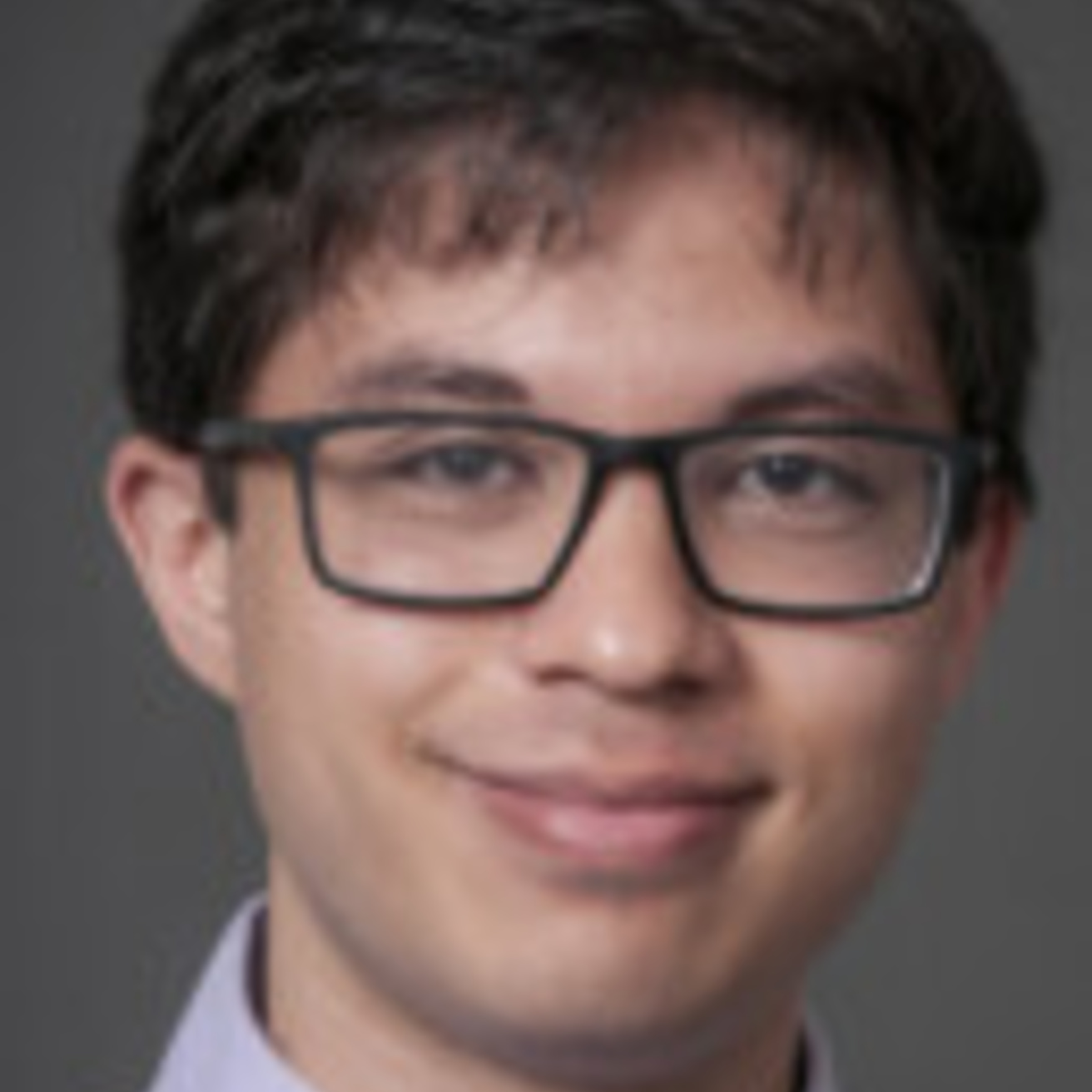 Photo of young man with short dark hair and glasses
