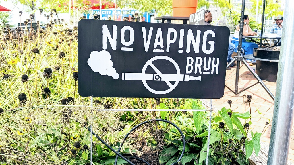 Sign at outdoor brewery reads "No vaping bruh"